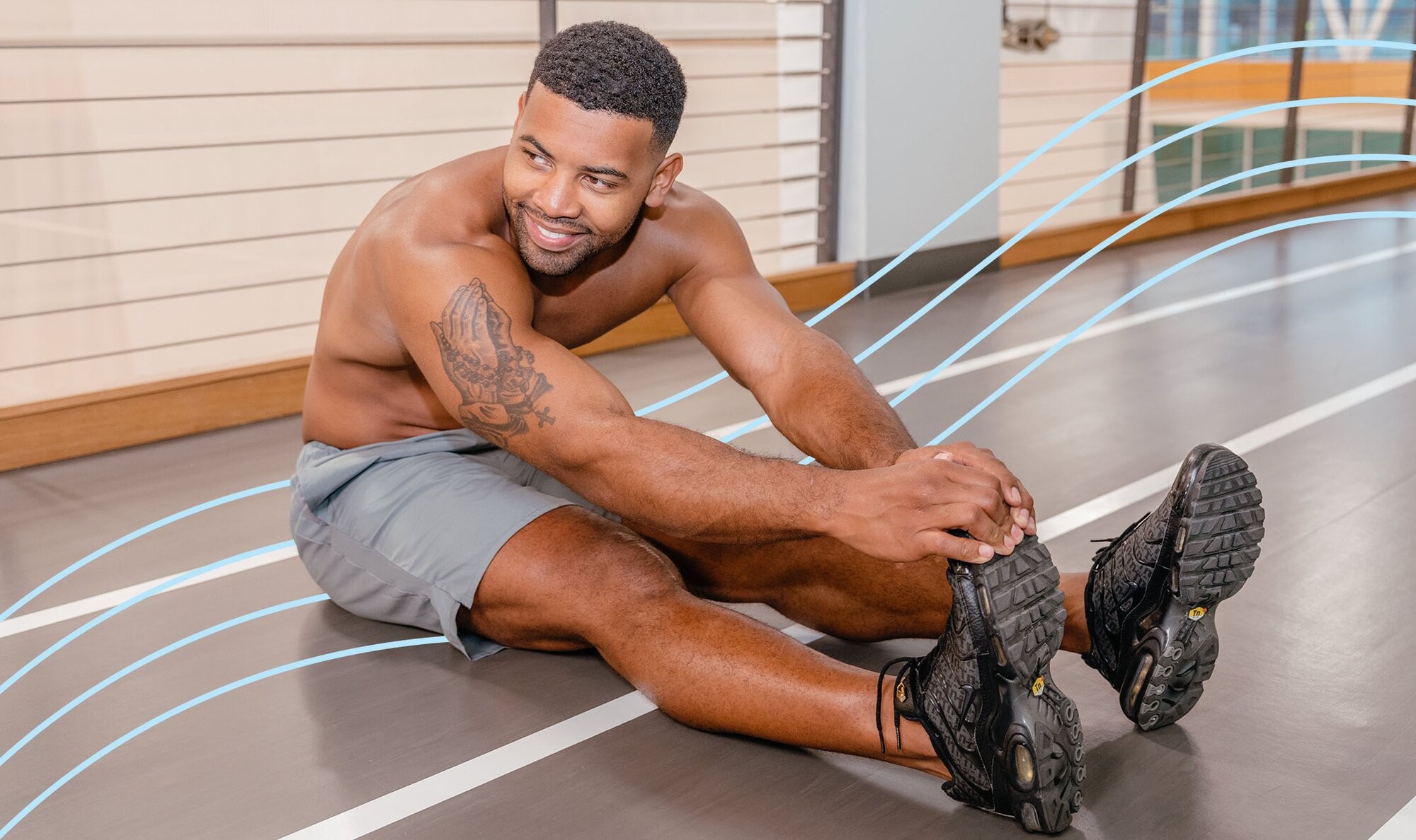 Man stretching on a gym track and brimming with confidence because he just had a men's brazilian laser hair removal treatment